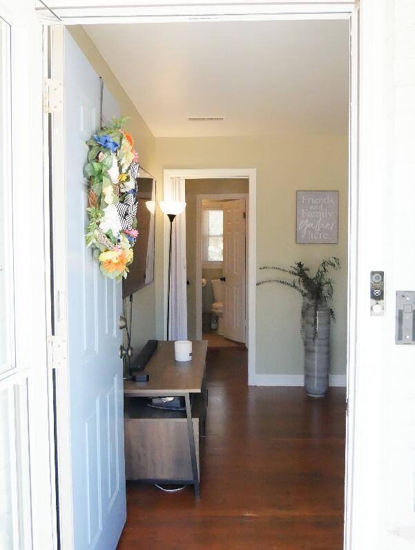 hallway with dark hardwood / wood-style flooring