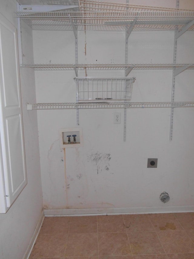 washroom with light tile patterned floors, hookup for a washing machine, and electric dryer hookup