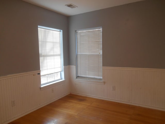 empty room with light hardwood / wood-style flooring