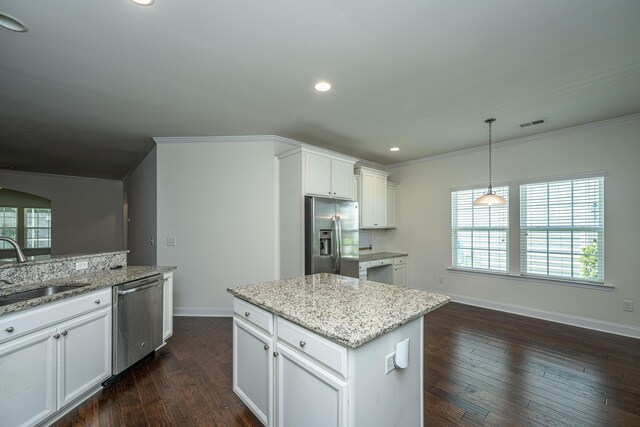 9710 Table Mountain Ln, Ladson, SC 29456 - kitchen featuring stainless steel appliances, ornamental molding, white cabinetry, dark wood-style flooring, and a center island