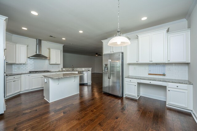 9710 Table Mountain Ln, Ladson, SC 29456 - kitchen featuring stainless steel appliances, wall chimney exhaust hood, decorative backsplash, recessed lighting, and a kitchen island