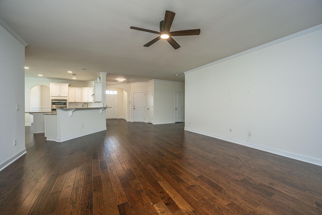 9710 Table Mountain Ln, Ladson, SC 29456 - unfurnished living room with arched walkways, ceiling fan, crown molding, dark wood-style flooring, and recessed lighting