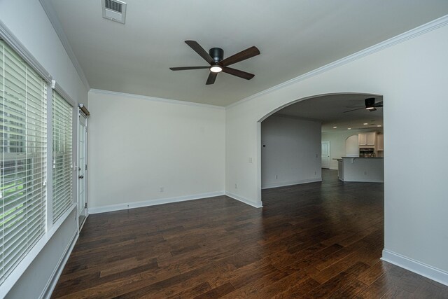 9710 Table Mountain Ln, Ladson, SC 29456 - unfurnished living room featuring ceiling fan, arched walkways, crown molding, and dark wood-style flooring