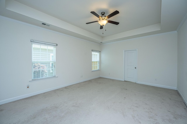 9710 Table Mountain Ln, Ladson, SC 29456 - spare room featuring a tray ceiling, light carpet, ceiling fan, and ornamental molding