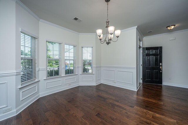 9710 Table Mountain Ln, Ladson, SC 29456 - unfurnished dining area featuring a chandelier, dark wood finished floors, wainscoting, ornamental molding, and a decorative wall