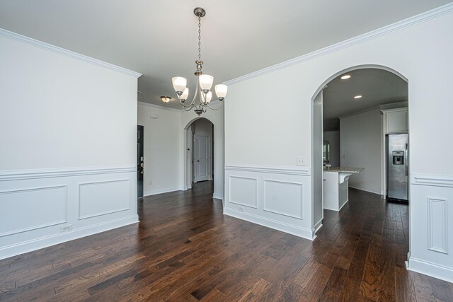 9710 Table Mountain Ln, Ladson, SC 29456 - empty room featuring arched walkways, dark wood-style flooring, ornamental molding, a chandelier, and wainscoting