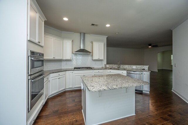 9710 Table Mountain Ln, Ladson, SC 29456 - kitchen featuring wall chimney exhaust hood, appliances with stainless steel finishes, a peninsula, dark wood finished floors, and recessed lighting
