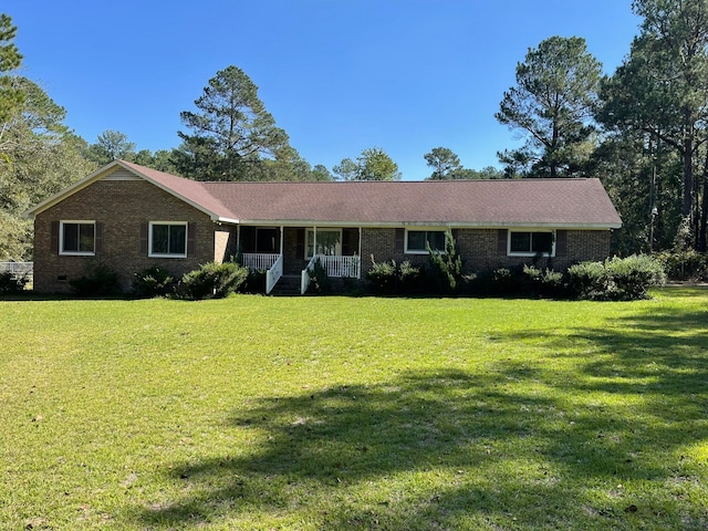 ranch-style house with a porch and a front lawn