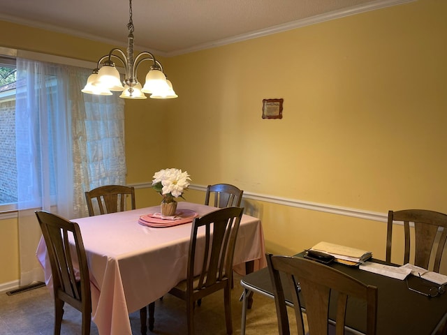 carpeted dining area with crown molding and a chandelier