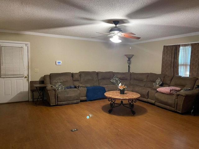 living room with ceiling fan, crown molding, hardwood / wood-style flooring, and a textured ceiling