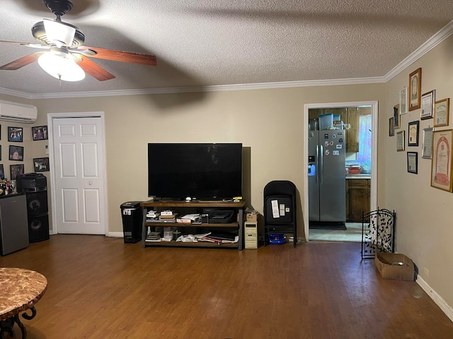 living room featuring ceiling fan, ornamental molding, a textured ceiling, dark hardwood / wood-style flooring, and an AC wall unit