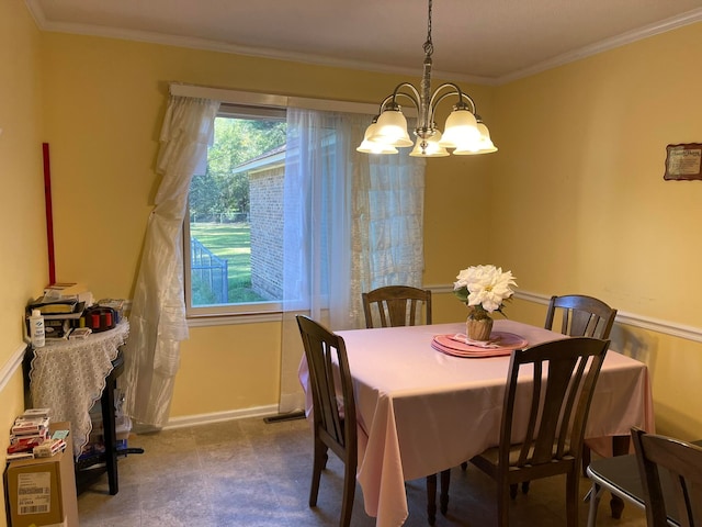 dining area featuring an inviting chandelier and crown molding