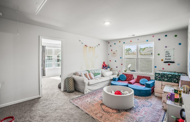 living room featuring baseboards, attic access, and carpet flooring