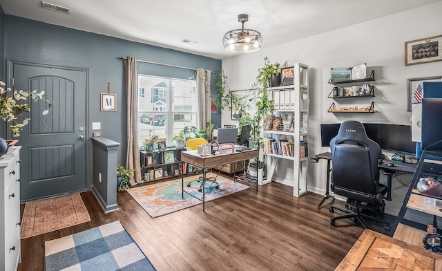 home office with visible vents, baseboards, and wood finished floors