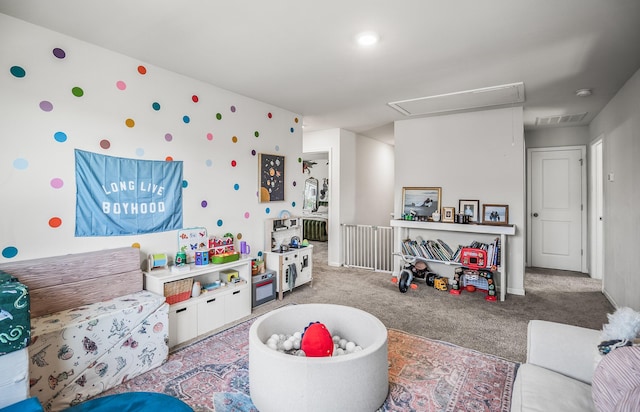 game room featuring visible vents, carpet, and attic access