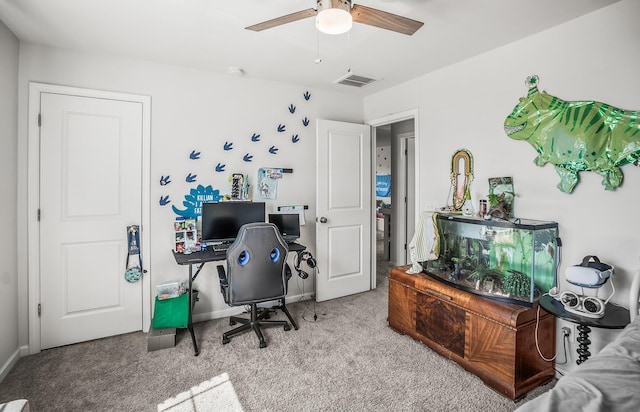 carpeted office space with visible vents, baseboards, and ceiling fan