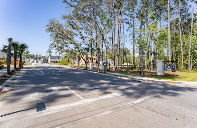 view of street with curbs, a residential view, and sidewalks