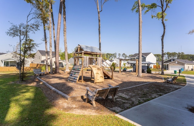 community play area with a residential view and fence