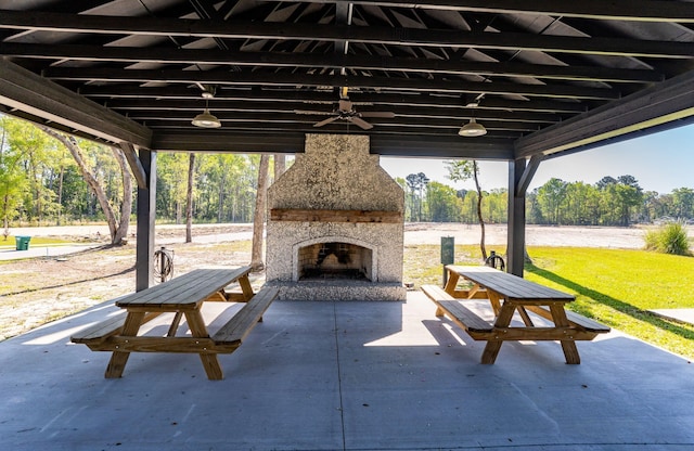 view of patio / terrace featuring an outdoor stone fireplace