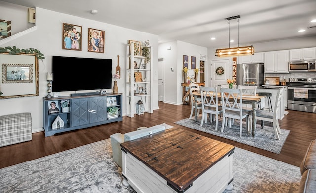 living area featuring dark wood finished floors, visible vents, recessed lighting, and baseboards