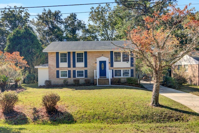 raised ranch with a front yard