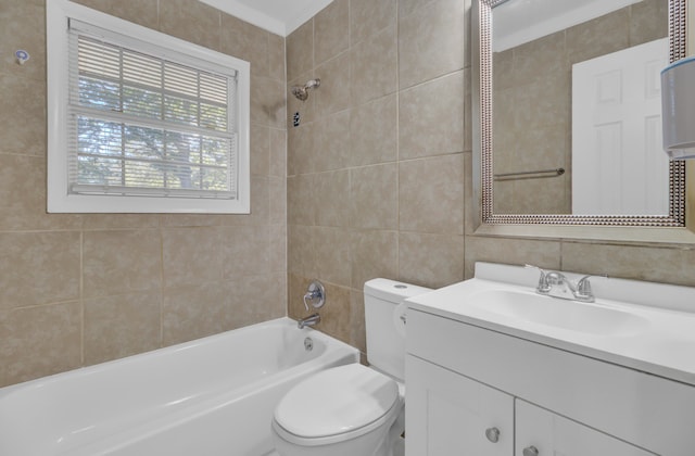 full bathroom featuring tiled shower / bath combo, toilet, tile walls, and vanity