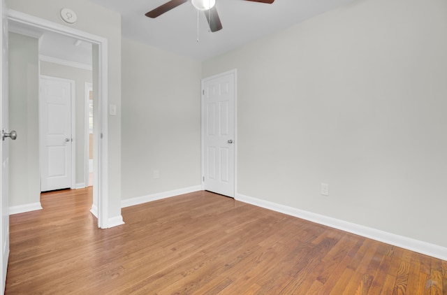 unfurnished room with light hardwood / wood-style flooring, ceiling fan, and crown molding