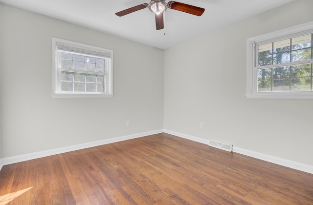 empty room with ceiling fan and wood-type flooring