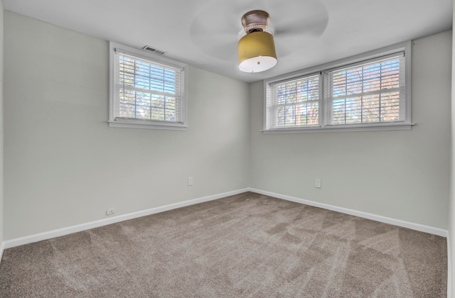 unfurnished room with carpet flooring, plenty of natural light, and ceiling fan