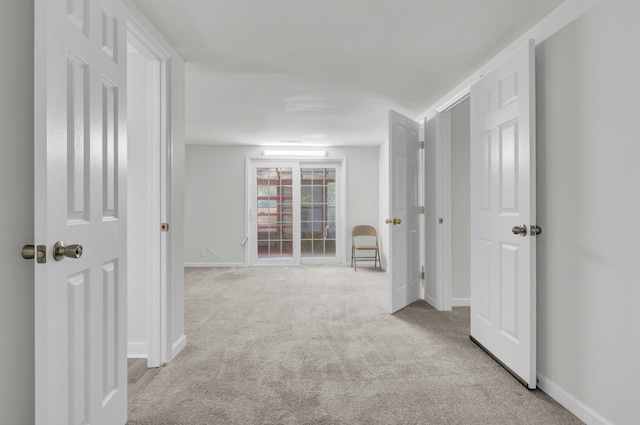 hallway featuring light carpet