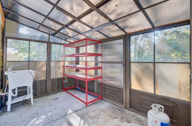 unfurnished sunroom with lofted ceiling