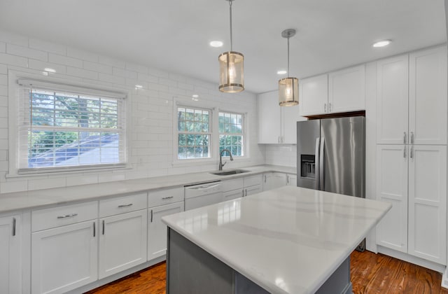 kitchen with dishwasher, dark hardwood / wood-style flooring, white cabinetry, and sink