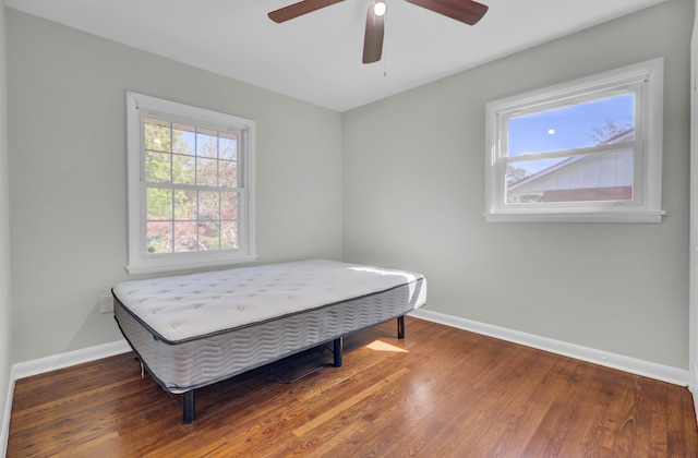 bedroom featuring dark hardwood / wood-style floors and ceiling fan