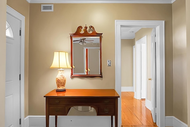 interior space featuring wood-type flooring and crown molding