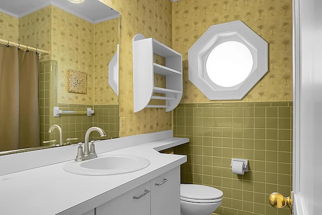 bathroom with toilet, vanity, tile walls, and curtained shower