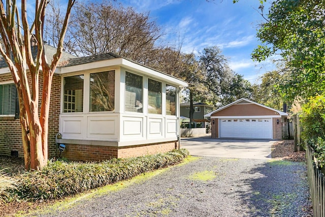 view of front of home featuring a garage and an outbuilding