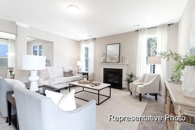 living room with a fireplace with flush hearth and visible vents