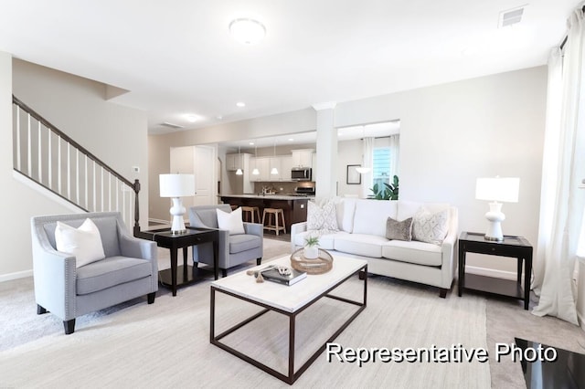 living area featuring recessed lighting, visible vents, stairway, and baseboards