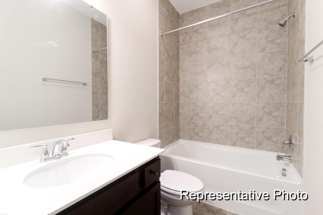 bathroom with toilet, vanity, and bathing tub / shower combination