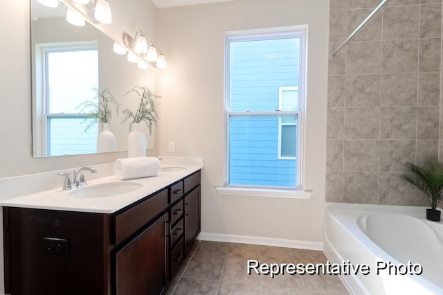 full bathroom with double vanity, a sink, tile patterned flooring, baseboards, and a bath