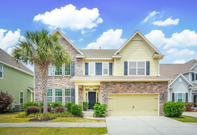 craftsman-style home featuring a garage, stone siding, driveway, and cooling unit