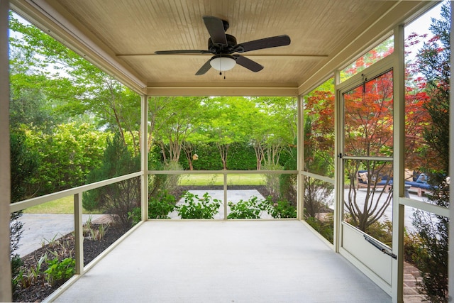 unfurnished sunroom featuring a ceiling fan