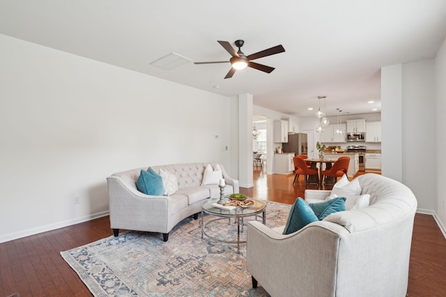 living room with wood finished floors, baseboards, a ceiling fan, and recessed lighting