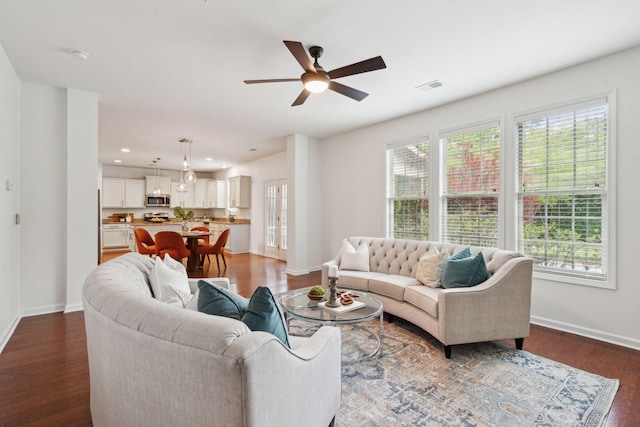 living room with baseboards, ceiling fan, dark wood-style flooring, and recessed lighting