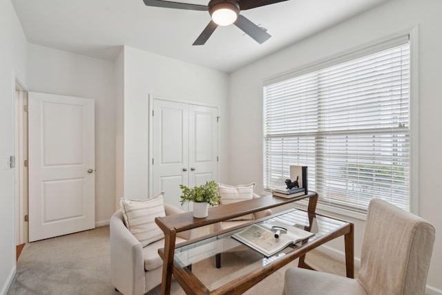 office area with plenty of natural light, baseboards, light colored carpet, and ceiling fan