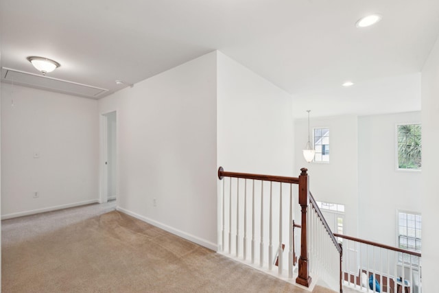 unfurnished room with attic access, carpet floors, baseboards, and recessed lighting