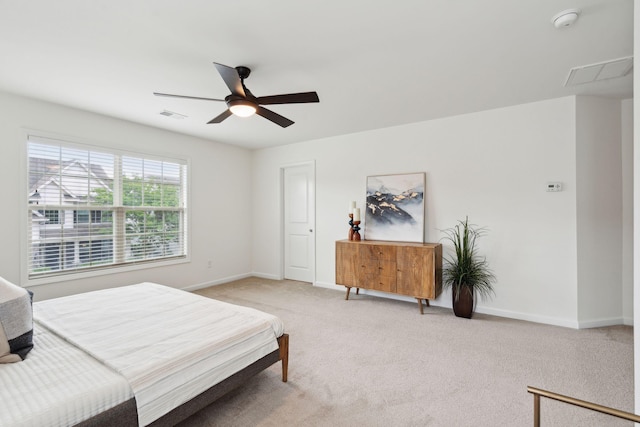 bedroom with light colored carpet, baseboards, and a ceiling fan