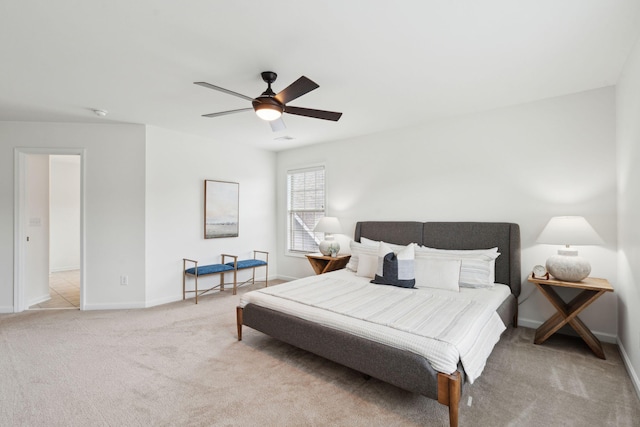 bedroom featuring light carpet, baseboards, and a ceiling fan