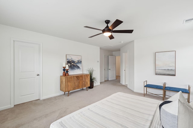bedroom featuring light carpet, baseboards, and ceiling fan