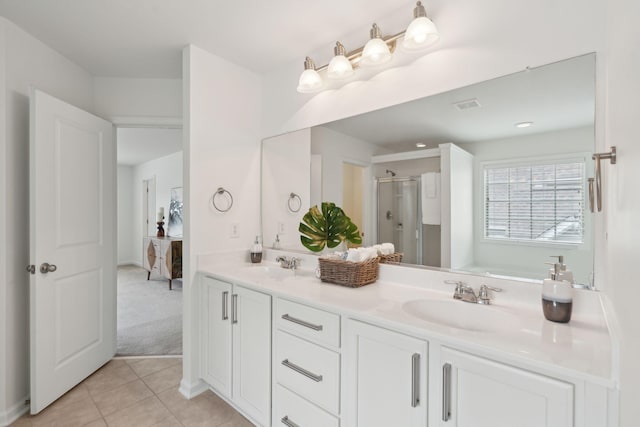 bathroom featuring a sink, a shower stall, visible vents, and tile patterned floors
